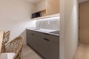 A compact kitchen with a granite countertop, a stainless steel sink, and a built-in oven. - 205 Fabulous Apt near La Diana/Reforma/U.S Embassy (Mexico City)