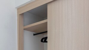 A wooden wardrobe with multiple shelves and a hanging rod. - 101 Extraordinary apartment next to The St. Regis. Regis (Mexico City)