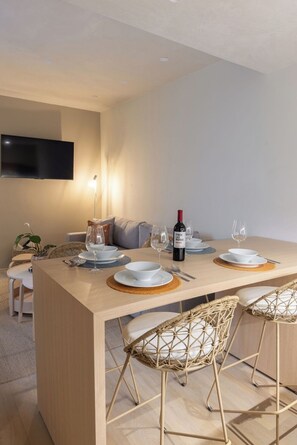 A modern dining area with a wooden table set for four, including plates, glasses, and cutlery. - 305 Fabulous Apt near La Diana/Reforma/U.S Embassy (Mexico City)