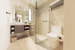 A modern bathroom with a glass-enclosed shower, a toilet, and a vanity with shelves. - 302 Fabulous Apt near La Diana/Reforma/U.S Embassy (Mexico City)