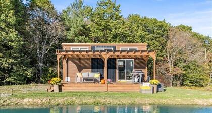 Waterfront Tiny House Perched on the Pond Covered Deck at Water’s Edge