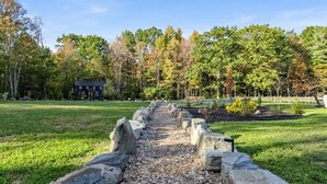 A pathway leading to a building surrounded by trees.