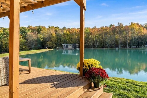 Waterfront Tiny House Perched on the Pond Covered Deck at Water’s Edge