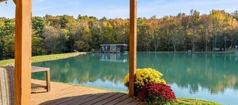 Waterfront Tiny House Perched on the Pond Covered Deck at Water’s Edge