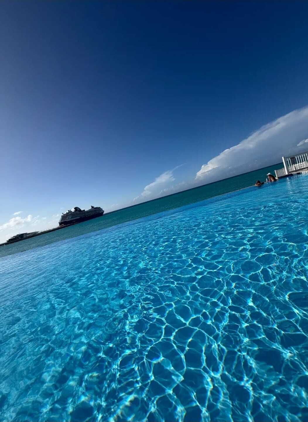 Resort-style pool overlooking the ocean, located just steps from the condo