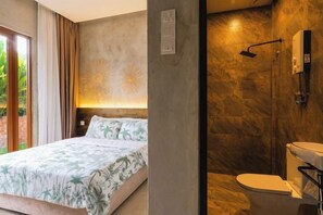 A bedroom with a bed, a bathroom with a toilet, and a shower area. - Chrisenbel Hideaway Retreat, The Villa Collection by Chrisenbel (Petaling Jaya)