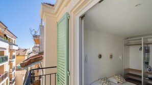 A bedroom with a bed, a nightstand, and a wardrobe. - Luxurious 2-bedroom with terrace 200m from Palais (Cannes)