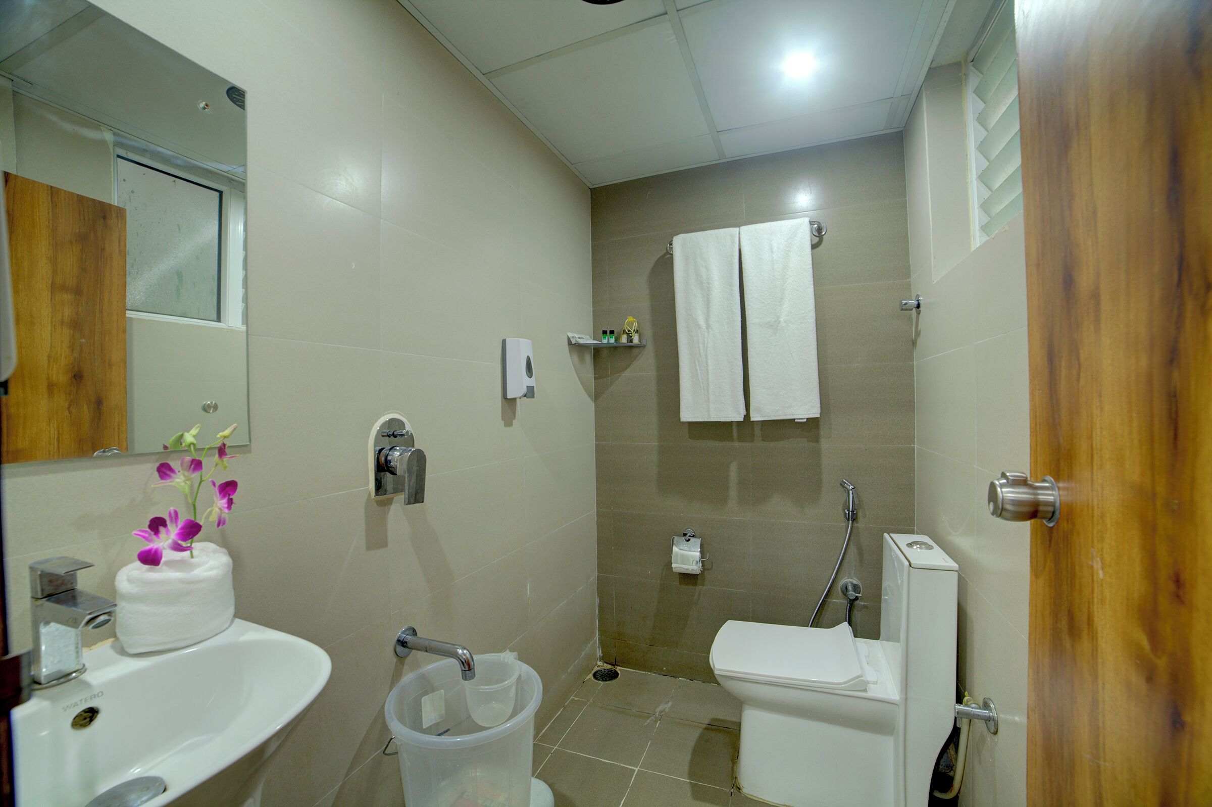 A bathroom with a sink, toilet, and shower.