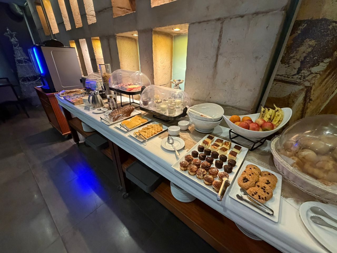 A buffet table with various food items and a coffee station.