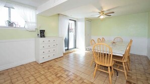 A dining area with a table and chairs, a ceiling fan, and a window with curtains. - Spacious 1 bedroom apartment, excellent location, separate entrance,safe & clean (Toronto)
