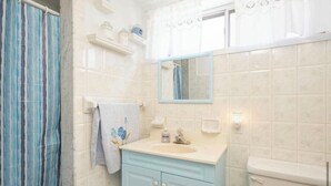 A bathroom with a shower, a sink with a mirror, and a toilet. - Spacious 1 bedroom apartment, excellent location, separate entrance,safe & clean (Toronto)