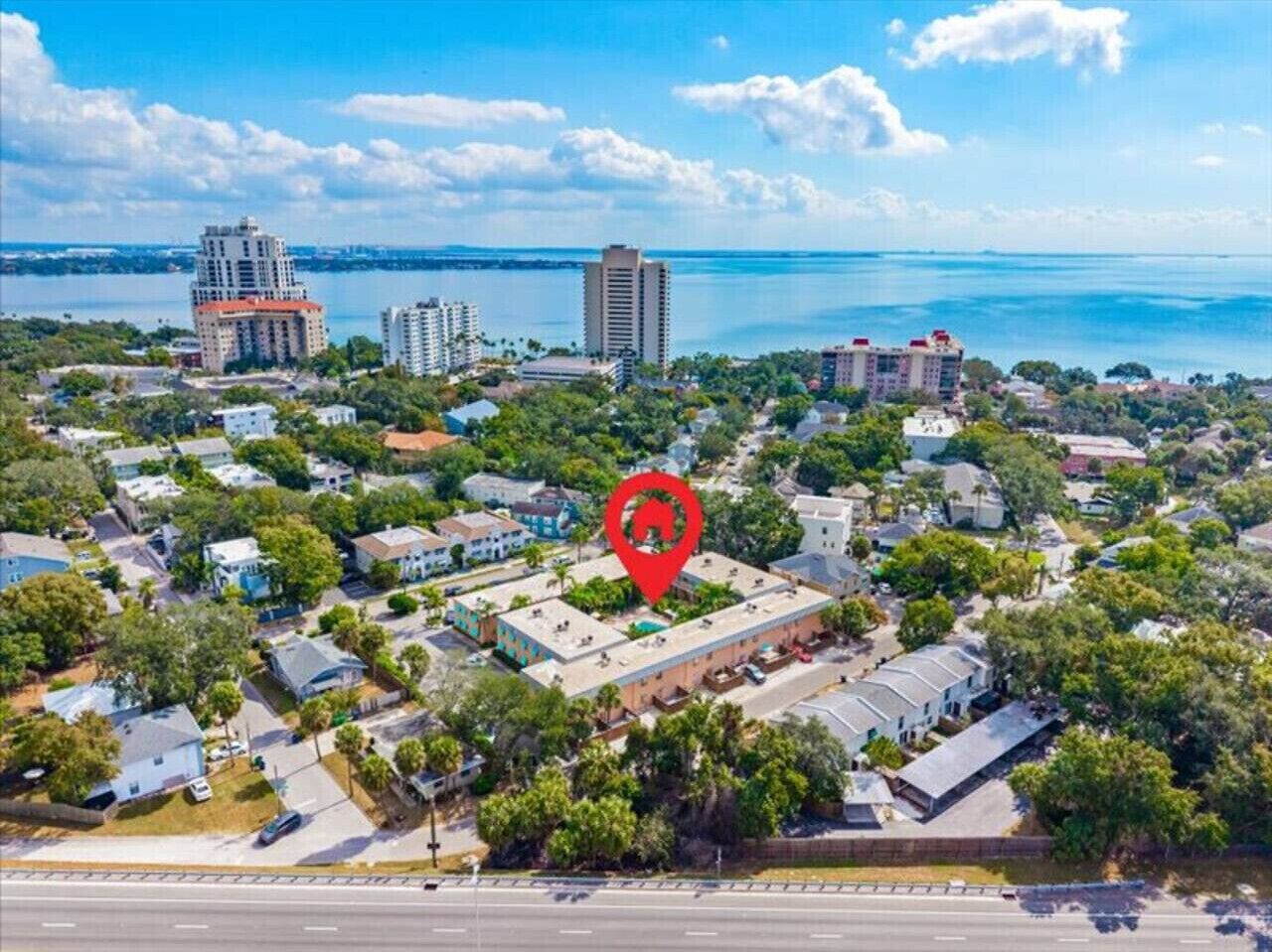An aerial view of a residential area with a prominent red location marker.