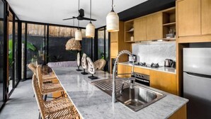 A modern kitchen with a marble countertop, stainless steel appliances, and a large island with seating. - Villa Alba by BaliSuperHost (Bali)
