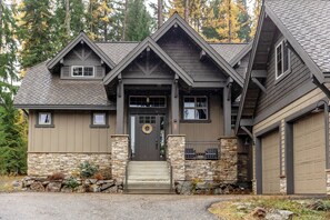 A two-story house with a stone foundation, a front porch, and a garage. - Sanctuary Retreat, Spacious 5BR Lodge w/ 13 Beds, 3.5 Baths in Cle Elum (Cle Elum)
