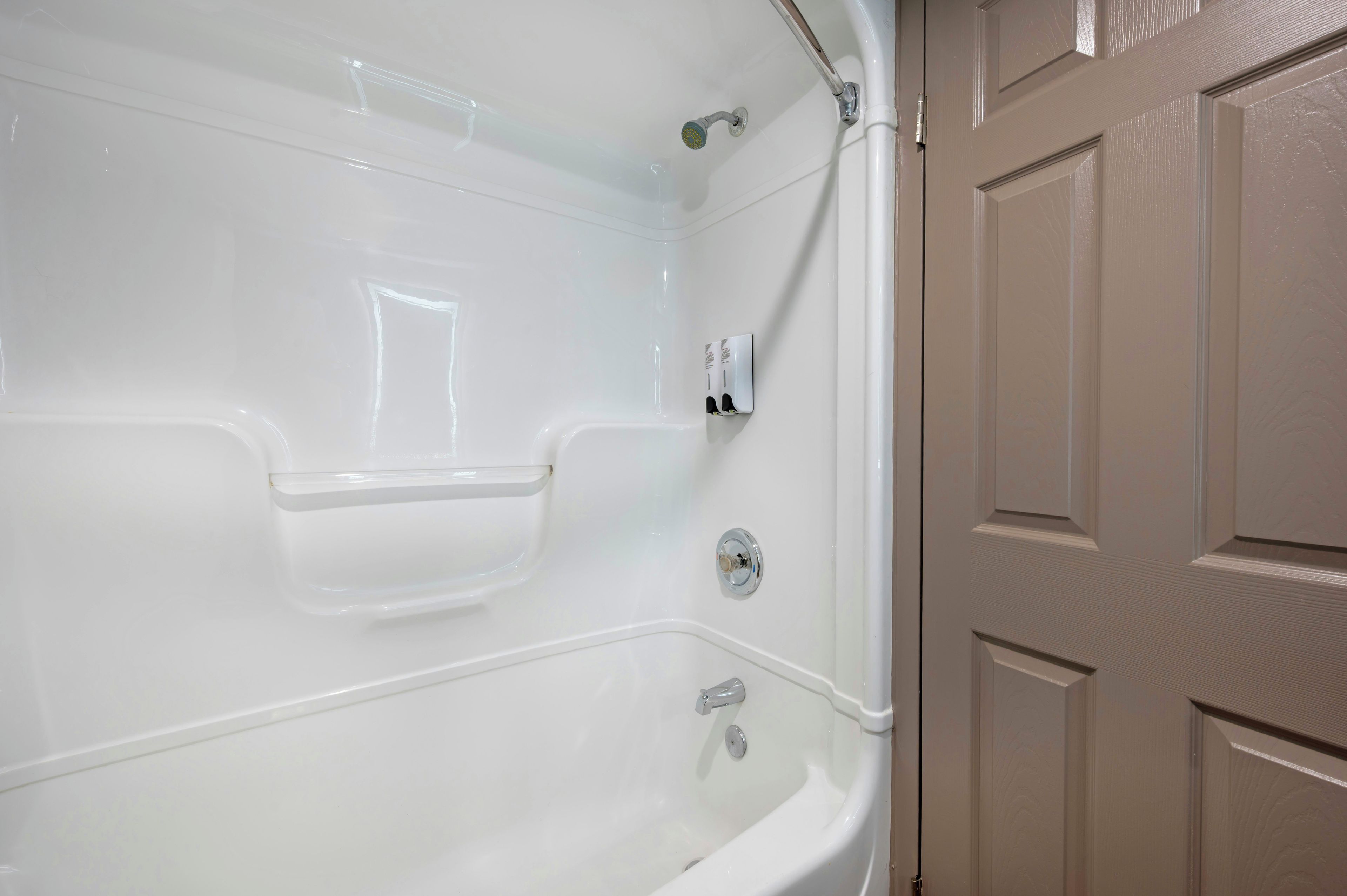 A bathroom with a bathtub, a shower, and a toilet.