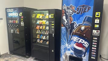 Three vending machines with various snacks and drinks, including a Pepsi machine.