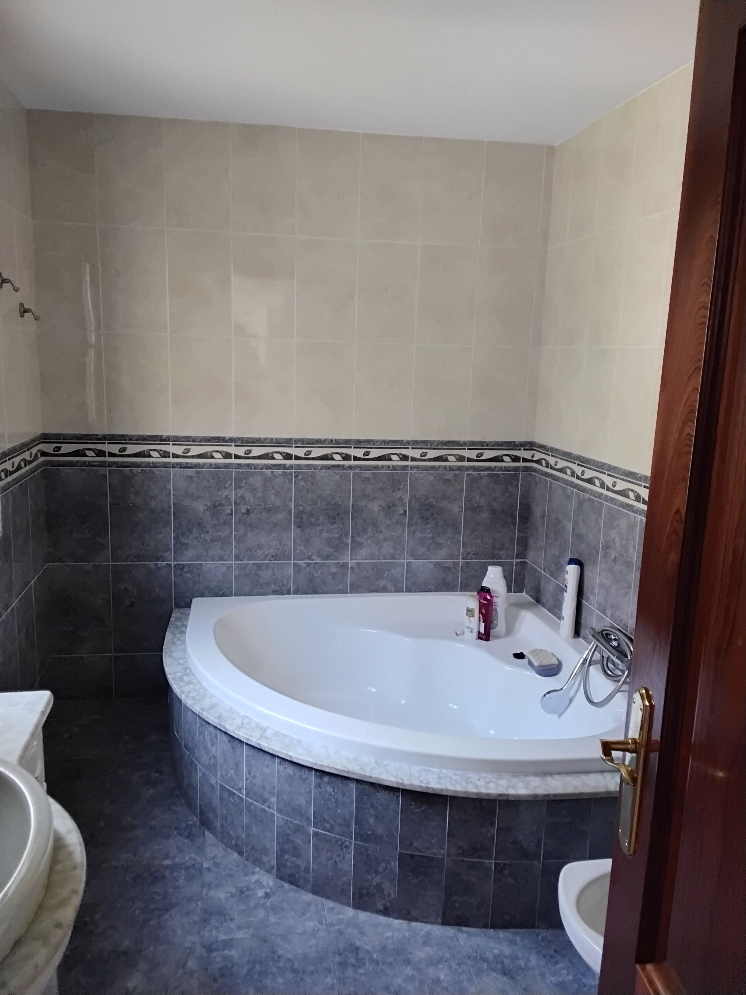Un baño con una bañera independiente, un inodoro y un lavamanos.