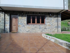 A stone building with a wooden door and a window.