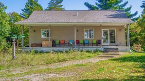 A single-story house with a porch, a small front yard, and a pathway leading to the entrance.