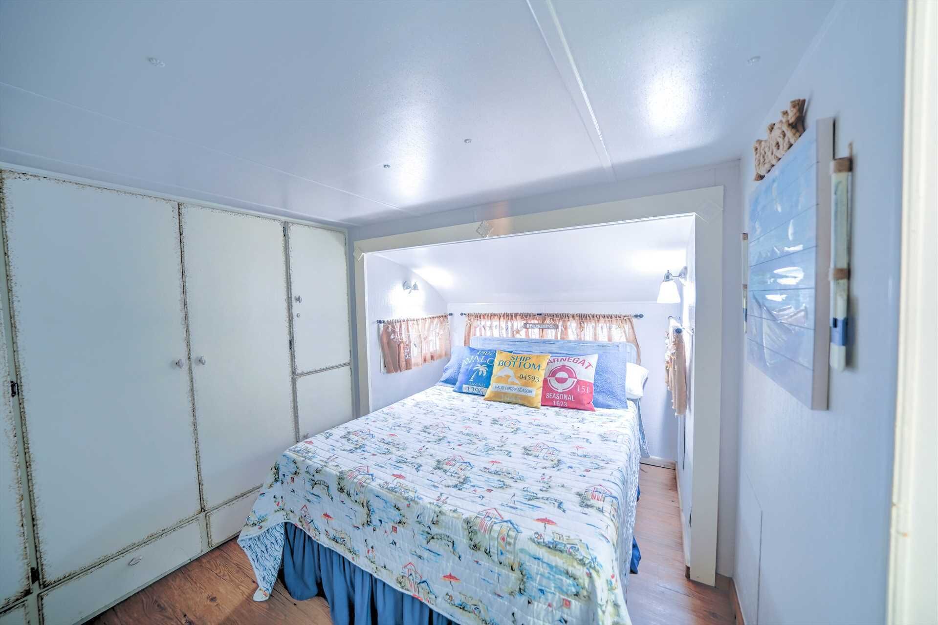 A bedroom with a bed, a wardrobe, and a door leading to another room.