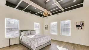 A bedroom with a bed, a ceiling light fixture, and a window with blinds. - 4 bed New Construction Home near airport/downtown (Atlanta)