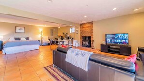 A modern living room with a sofa, a TV, a fireplace, and a dining area. - Mountain View Retreat, Year Round Sunshine
1 bed, 1 renovated bath in Boulder (Boulder)