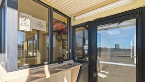 A closed storefront with a 'No Pets Allowed' sign, a 'No Visitors Allowed' sign, and a 'OPEN' neon sign. - Luxury Inn By Hotel O Hattiesburg, MS (Hattiesburg)