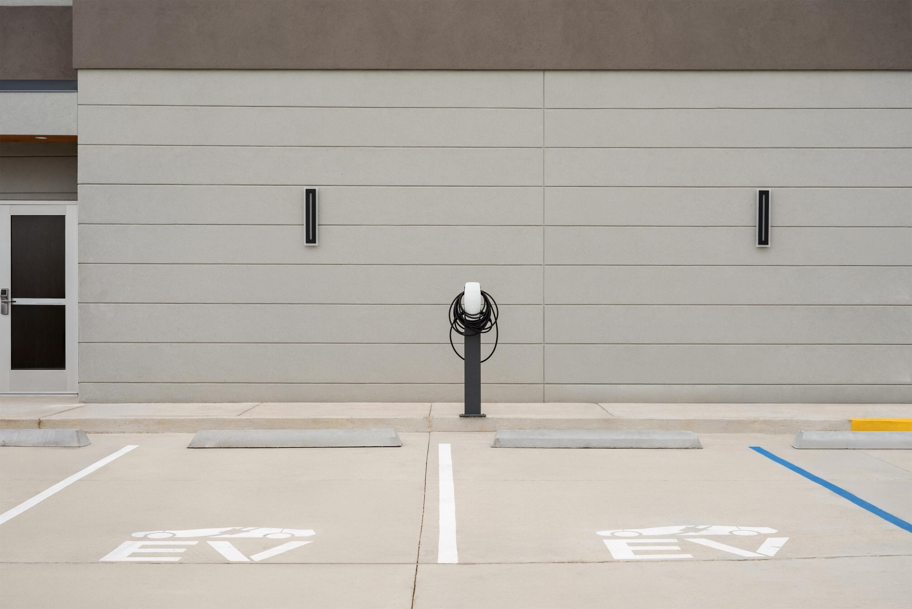A parking area with EV charging stations and designated EV parking spaces.
