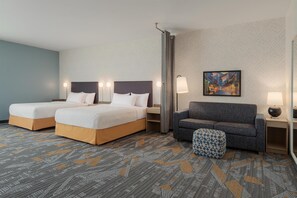 A hotel room with two beds, a sofa, a patterned carpet, and a painting on the wall. - Home2 Suites By Hilton Lafayette I-10 (Lafayette)
