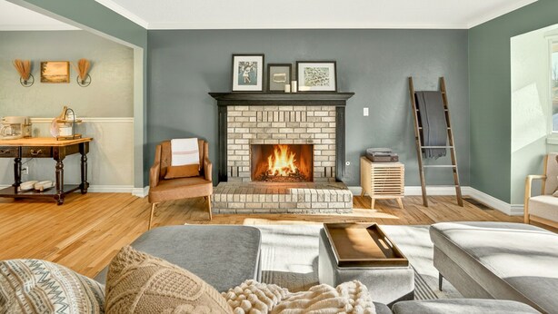 A living room with a brick fireplace, wooden furniture, and a ladder against the wall. - Jville Gem- Walk downtown (Jacksonville)
