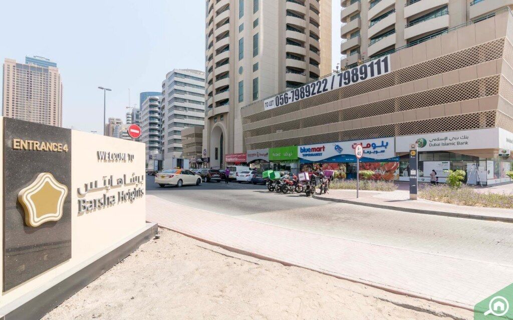 A commercial building with a sign for 'Entrance 4' and 'Welcome to Jumeirah Heights'.