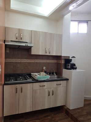 Fridge, microwave, coffee/tea maker, cookware/dishes/utensils