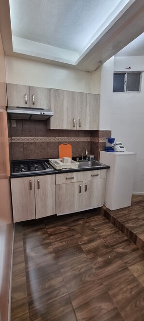 Fridge, microwave, coffee/tea maker, cookware/dishes/utensils
