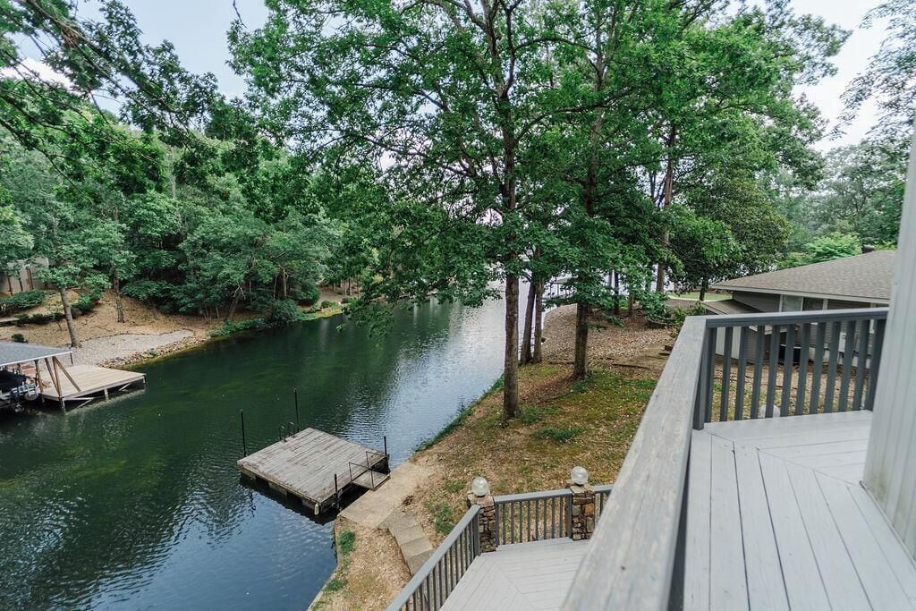 A riverside deck with a dock and a stone pathway.