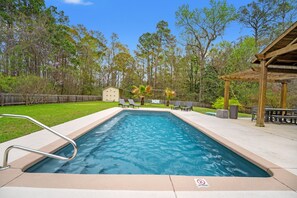 A rectangular swimming pool with a metal ladder, surrounded by a wooden deck and a covered seating area. - Sleeps 10 - Private Pool - Close to Folly & Kiawah (Johns Island)
