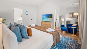 A hotel room with a bed, a TV, a desk, a chair, and a ceiling fan. - Close 2 DT & Beaches | 4 BR 10 Guests | Built 2025 (Charleston)