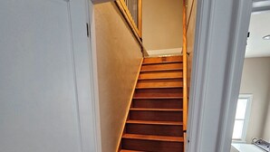 A staircase with wooden steps leading to a landing.