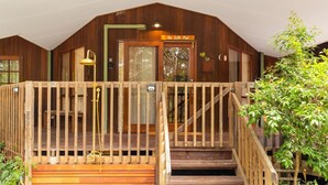 A wooden cabin with a sign reading "The Lilli Pod" above the entrance. - The Lilli Pad- A Tranquil Garden Stay (Lilli Pilli)