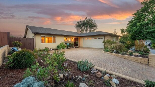 A single-story house with a garage, surrounded by landscaped gardens and a paved driveway. - Quiet and Spacious 4BR Goleta Home with a Big Yard and Near Beaches & UCSB (Goleta)