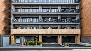 A multi-story building with a modern design, featuring balconies and large windows. - Apartment Hotel 11 Nambaminami 5 (Osaka)