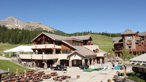 Un chalet comprenant plusieurs bâtiments, des espaces de repos en plein air et un espace piscine.