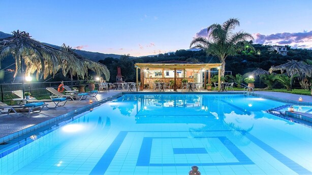 A swimming pool with lounge chairs and a bar area. - Villa Galini Sifis (Apokoronas)