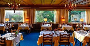 A restaurant with multiple tables, each set with cutlery and glasses, and chandeliers hanging from the ceiling. - Perwanger (Fie allo Sciliar)