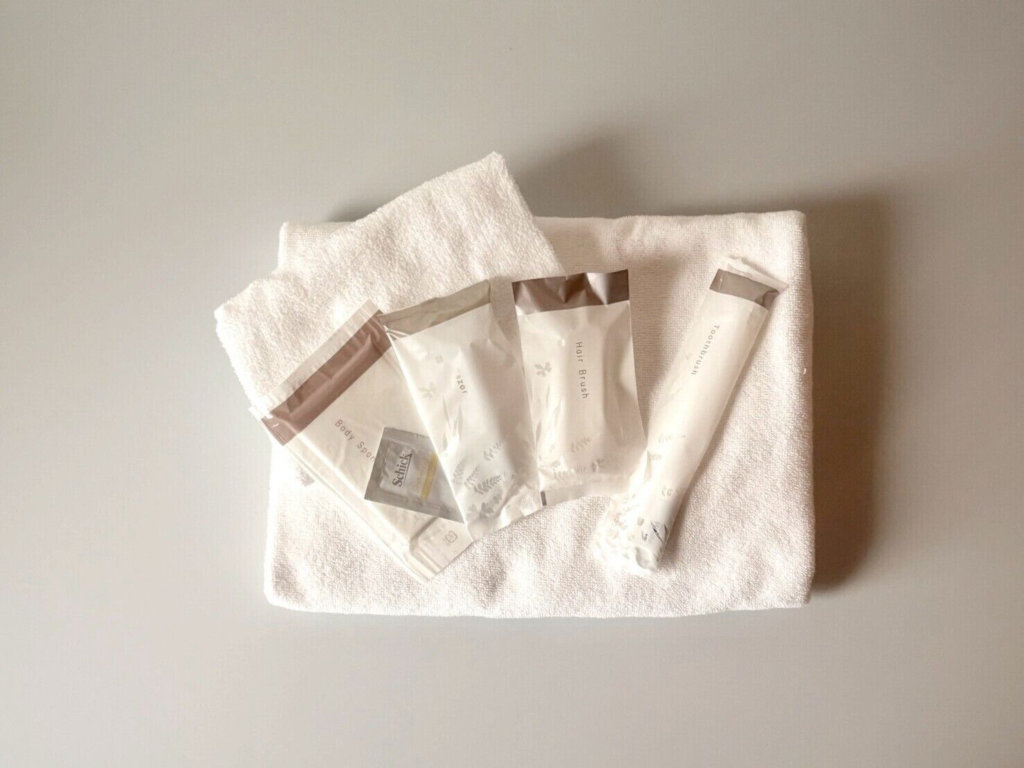 A white towel with three white tubes on it.