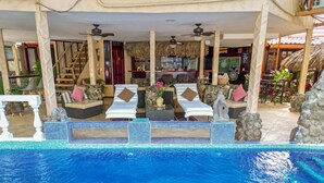 A poolside area with lounge chairs, a bar, and a staircase leading to an upper level. - "Casa Meloso" mit eigenem Pool by Interhome (Huacas)