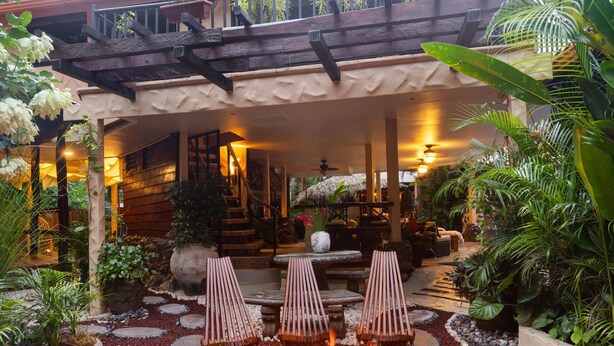 An outdoor patio area with a fire pit, lounge chairs, and a staircase leading to an upper level. - "Casa Meloso" mit eigenem Pool by Interhome (Huacas)