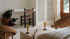 A bedroom with a bed, a chair, a wardrobe, a mirror, and a potted plant. - Raes on Wategos  (Byron Bay)