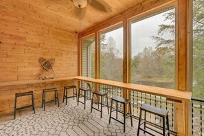 A wooden cabin with a balcony, large windows, and a patterned floor. - Wine Country Waterfront • 100 Acres • Sleeps 16 (Jefferson)