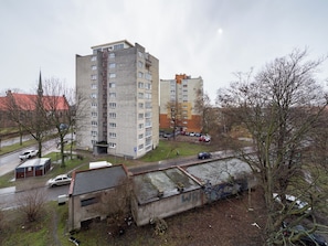 A multi-story residential building with a parking area in front. - Głęboka Harmony Studio (Gdańsk)