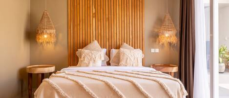 A modern bedroom with a wooden bed, two bedside tables, and a large window with curtains.